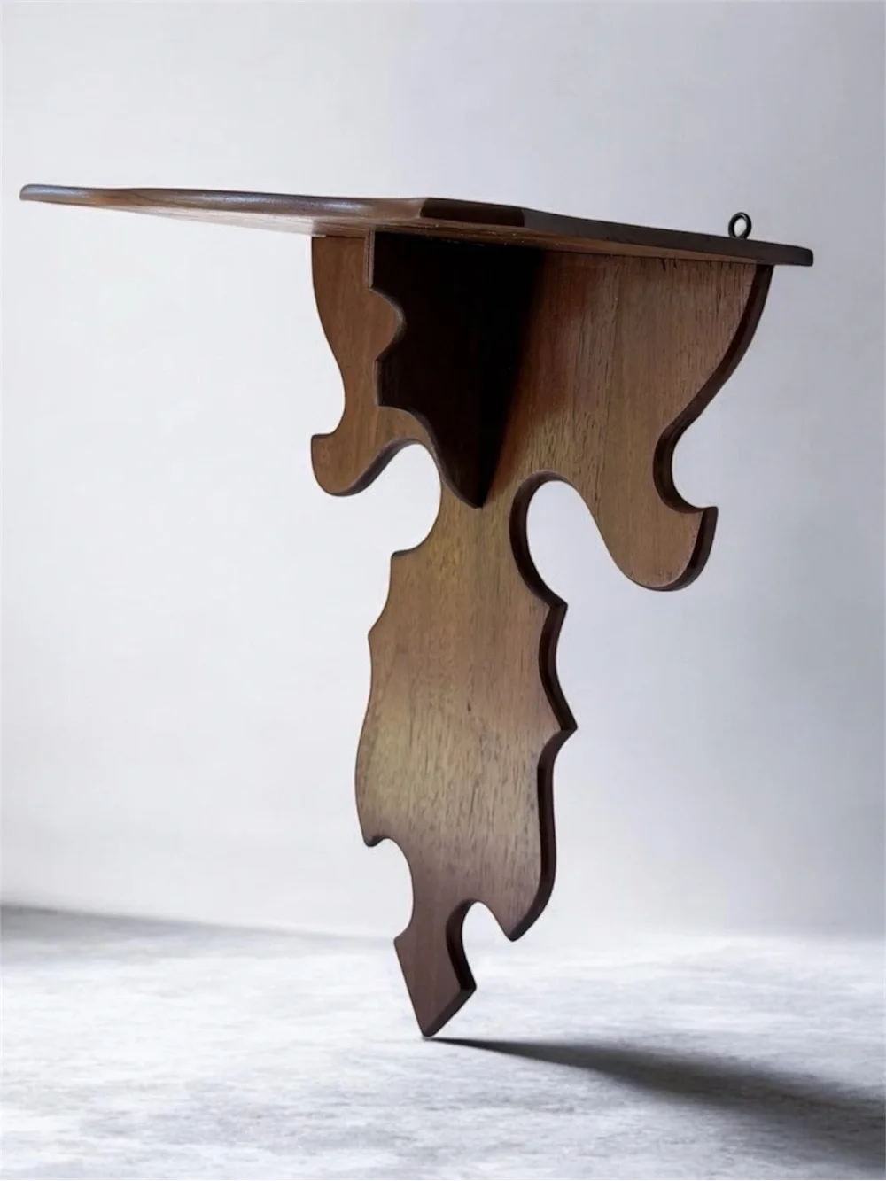 vintage wall sconce shelf made of carved wood with a dark finish